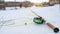 Beautiful winter fly fishing picture. Fly rod and reel on snowy river bank