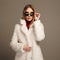 Beautiful winter girl in white fur and sunglasses. winter fashion.young woman