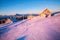 Beautiful winter landscape with abandoned cabins at sunrise