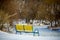 Beautiful winter landscape with frosen river and the bench snowy scene.