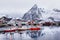 Beautiful winter landscape of harbor with fishing boat and traditional Norwegian rorbus