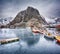 Beautiful winter landscape of harbor with fishing boats and traditional Norwegian rorbus