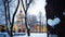 Beautiful winter landscape with heart of snow on tree trunk and Spire of Admiralty building, Saint Petersburg, Russia