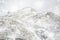 Beautiful Winter landscape image around Mam Tor countryside in Peak District England with lone hiker in heavy snow storm