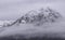 Beautiful Winter landscape image of snowcapped peak of Stob Dearg Buachaille Etive Mor in Glencoe, Rannoch Moor