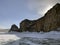 A beautiful winter landscape with majestic ice-covered rocks, mountains and hills