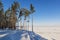 Beautiful winter landscape with pine forest and iced lake