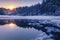 Beautiful Winter Landscape with Pine Forest and Sunset Reflections in a Lake full of Ice Pack