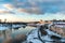 Beautiful winter landscape on the river along the embankment. The water reflects light from clouds, old buildings and churches.