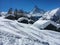 Beautiful winter landscape with snow covered cottages in front of Matterhorn mountain