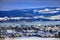 Beautiful winter scenery, hills, wood, lake, little country houses and white church covered with snow