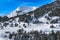 Beautiful winter scenery, mountains and forest covered in snow, people hiking in Andorra