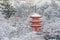 Beautiful winter season of Red Pagoda at Kiyomizu-dera temple surrounded with trees covered white snow background.