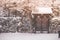 Beautiful winter seasonal view old wooden door with roof covered with white snow.