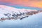 Beautiful winter sunrise landscape, famous ski resort with typical alpine wooden houses in French Alps, Les Menuires, 3 Vallees,