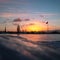 A beautiful winter sunrise landscape in Latvia capital Riga with frozen river Daugava.