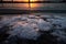 A beautiful winter sunrise landscape in Latvia capital Riga with frozen river Daugava.