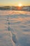 Beautiful winter sunrise scenery with footprints in fresh snow