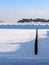 Beautiful winter view of Finnish archipelago with buoys standing in the frozen sea