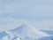 Beautiful winter volcanic landscape of Kamchatka Peninsula: view of eruption active Klyuchevskoy Volcano at sunrise. Eurasia,