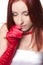 A beautiful wistful redhead woman in red gloves