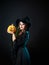 Beautiful witch in a pointed hat Holding a pumpkin with a laughing face.