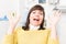 Beautiful woman acting terrify while sitting on dental chair