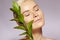 Beautiful Woman applies Organic Cosmetic. Spa and Wellness. Model with Clean Skin. Healthcare. Picture with Leaf