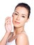 Beautiful woman applying cosmetic cream on face