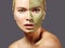 Beautiful Woman Applying Green Facial Mask. Beauty Treatments. Close-up Portrait of Spa Girl Apply Clay Facial mask