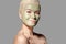 Beautiful Woman Applying Green Facial Mask. Beauty Treatments. Spa Girl Apply Clay Facial mask on grey background