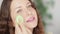 Beautiful woman applying natural organic makeup using beauty blender and smiling, eco make-up sponge tool, face portrait
