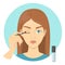 Beautiful woman applying primer for eyeshadow on eyelid