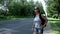 Beautiful woman with backpack and sunglasses hitch hiking car on road