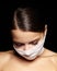 Beautiful woman with bandage mask on face. Fashion eye make-up. Beauty surgery or protection hygiene in virus pandemic