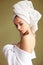 Beautiful woman in bath robe with a towel on her head looking thoughtfully into the camera