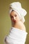 Beautiful woman in bath robe with a towel on her head looking thoughtfully off the camera
