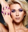 Beautiful woman with beauty purple manicure and makeup of eyes.