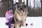 A Beautiful woman with a big fluffy dog in nature, Caucasian guard sheepdog