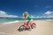 Beautiful woman on the bike on the beach