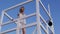 Beautiful woman in bikini standing at the lifeguard station, lifeguard tower.