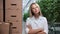 Beautiful woman biology scientist plant genetic engineer posing at greenhouse with harvest box