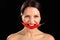 Beautiful woman biting on red chili pepper