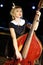 Beautiful woman in black dress plays old contrabass