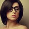 Beautiful woman with black hair in fashion glasses