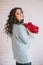 Beautiful woman in blue coat with red roses in craft paper