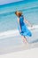 Beautiful woman in blue dress on beach in summer