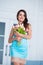 Beautiful woman in blue nightie standing with a bouquet of spring tulips. Girls love gifts flowers. March 8 Women`s Day