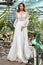 Beautiful woman bride in long white wedding dress espousal fashion marriage celebration big day in green park garden backyard