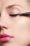 Beautiful woman with bright make up eye with black liner makeup. Fashion arrow shape. Chic evening make-up. Makeup beauty wit